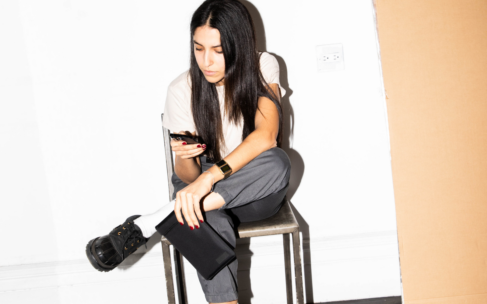 Women on phone holding a SLNT Faraday Phone Sleeve