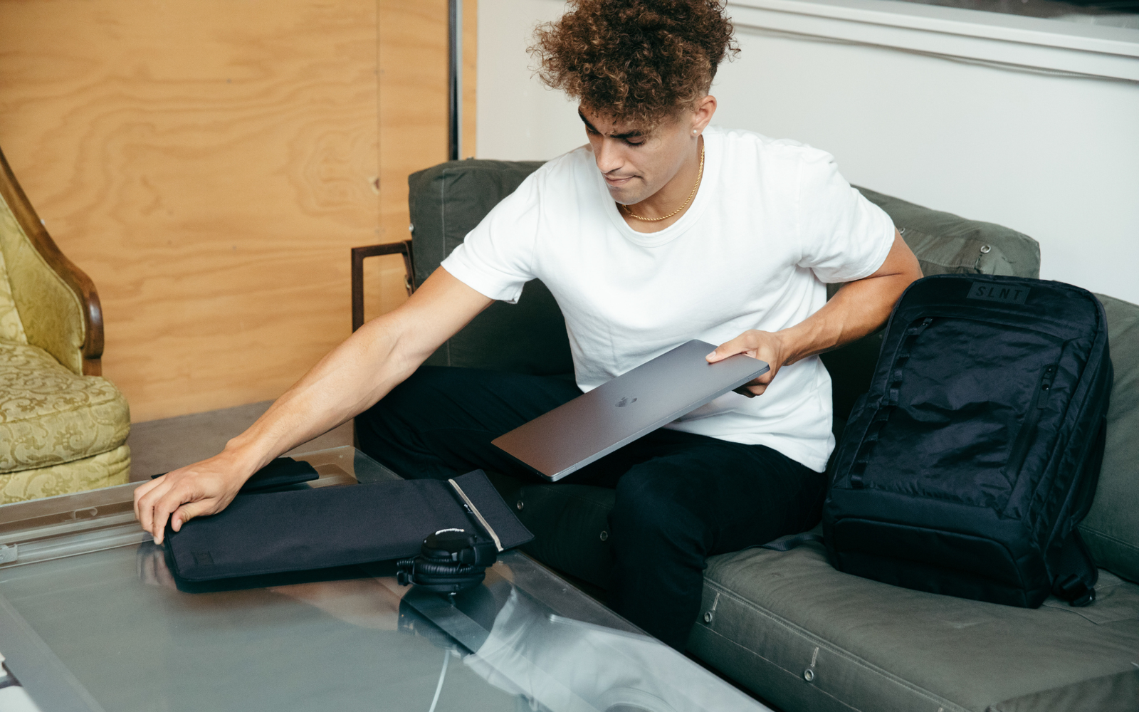 man placing a laptop into a SLNT Faraday sleeve for laptops