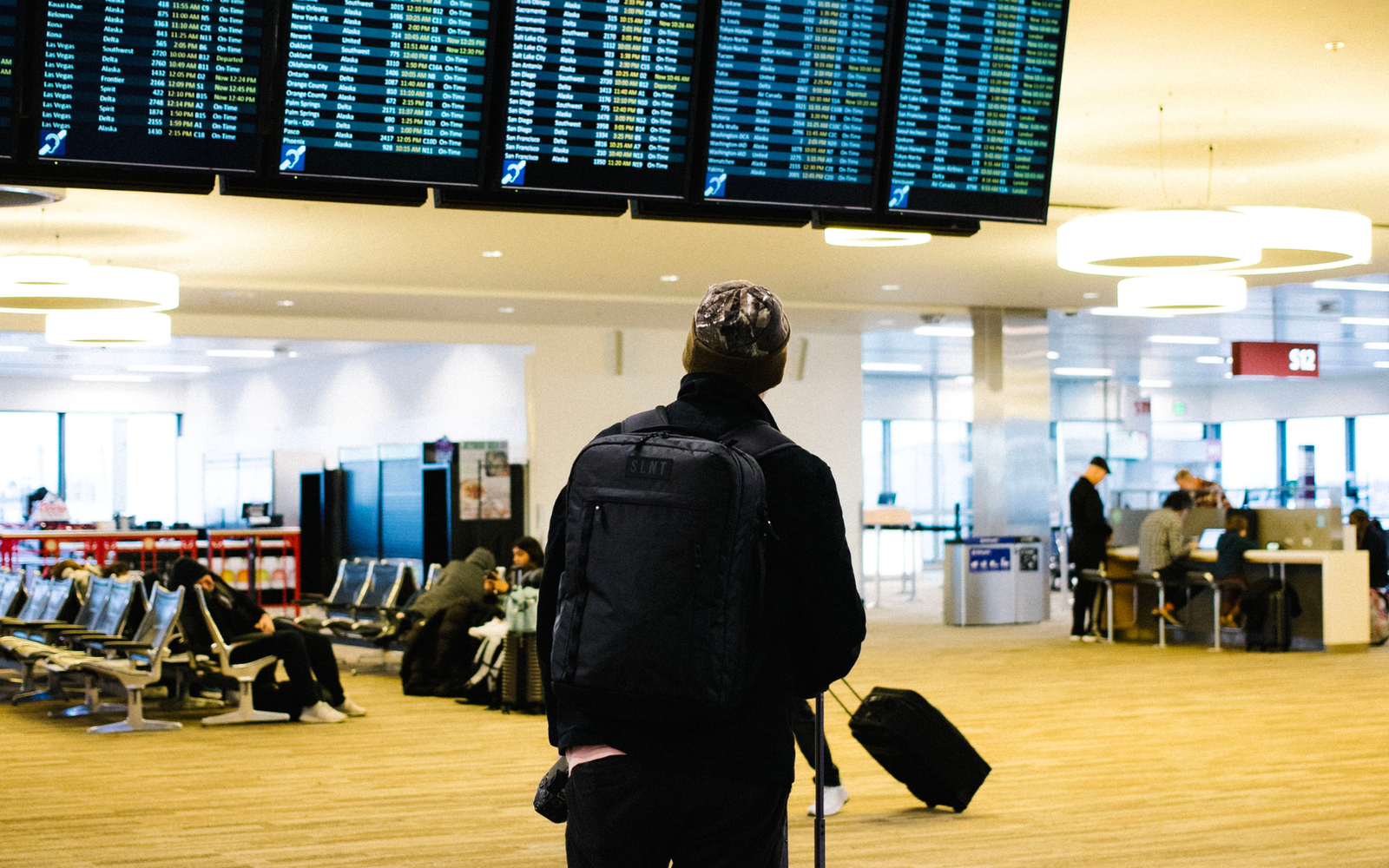 Traveler with SLNT backpack at airport