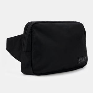 Side-angle view of the black Faraday sling by SLNT, highlighting its compact and secure design.