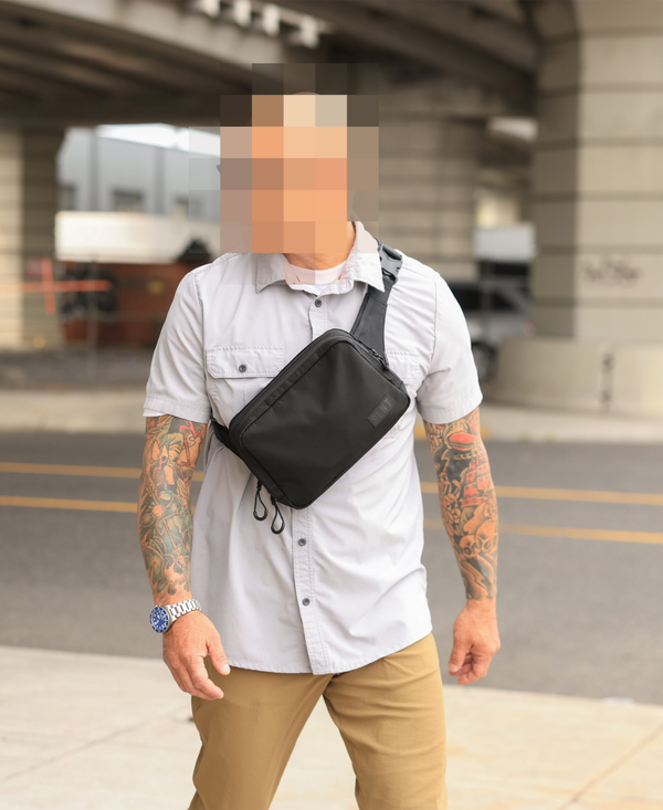 A man wearing the concealed carry Faraday sling