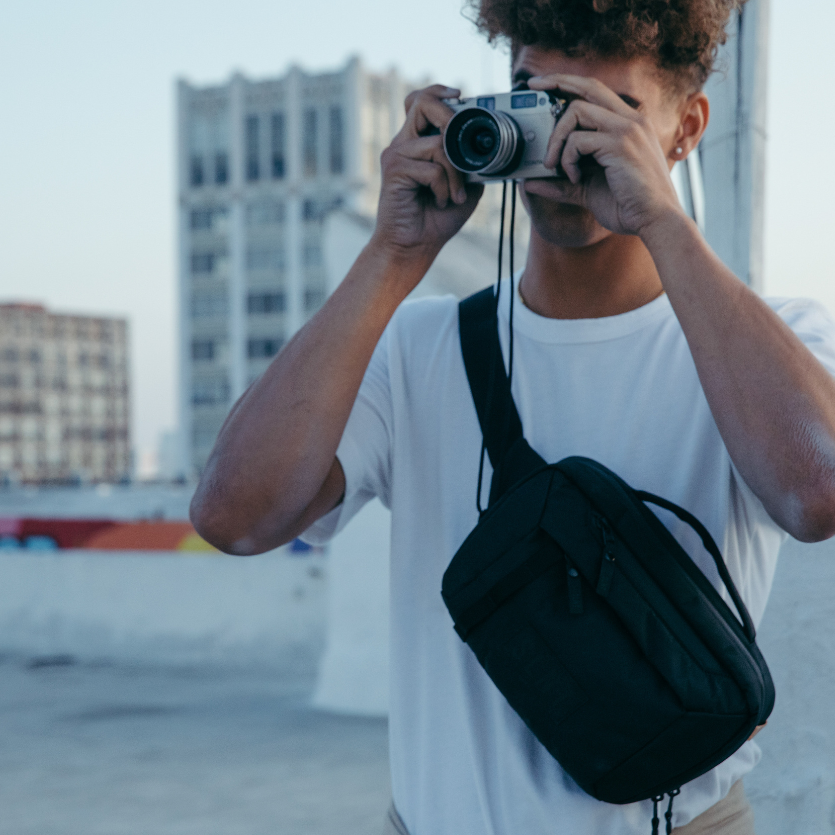 Man with camera and Faraday Crossbody Bag
