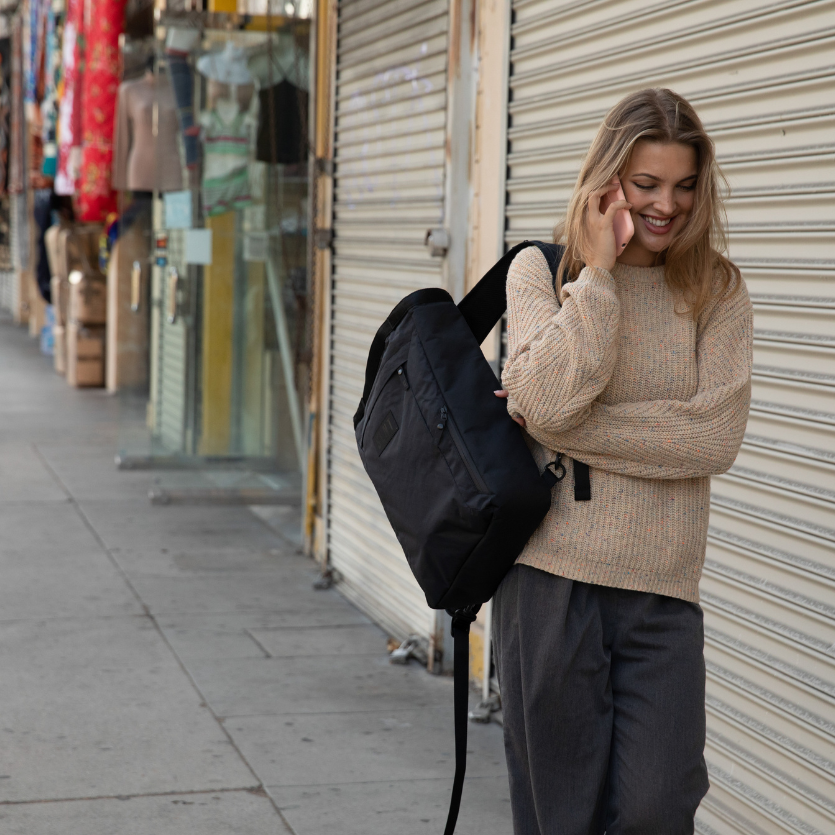 Girl on phone with Faraday Tote 
