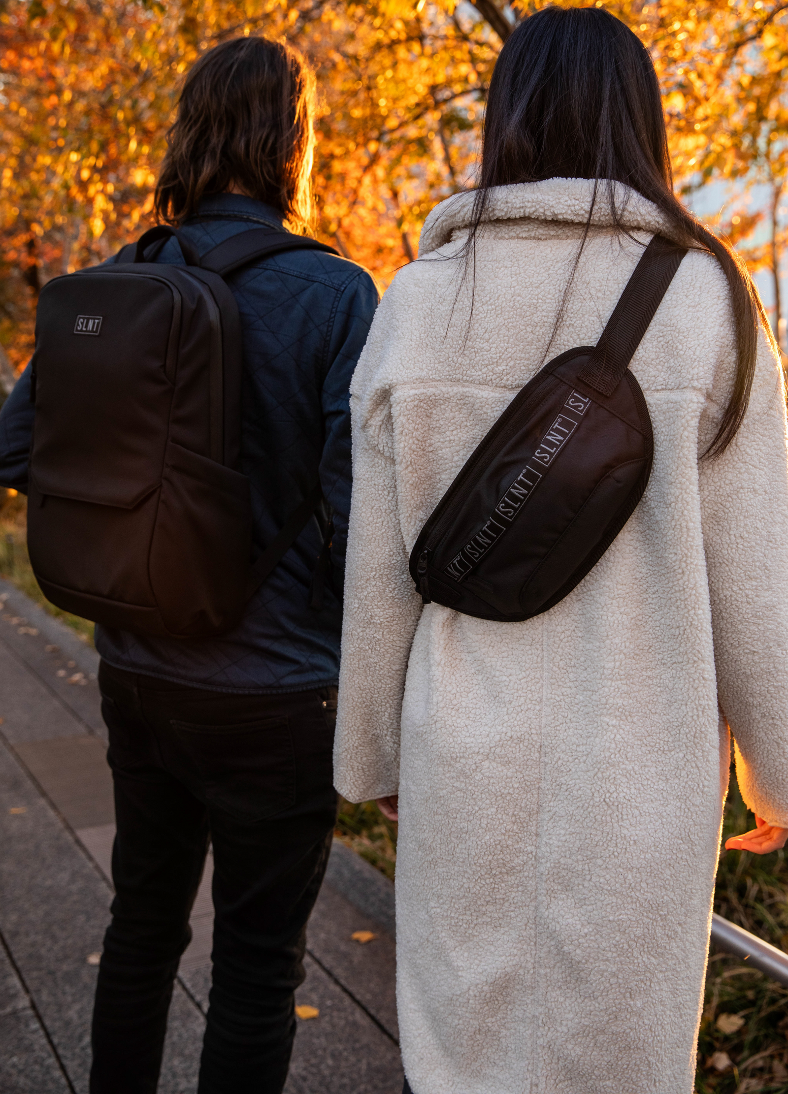 Man and women wearing Essential Faraday Bags 