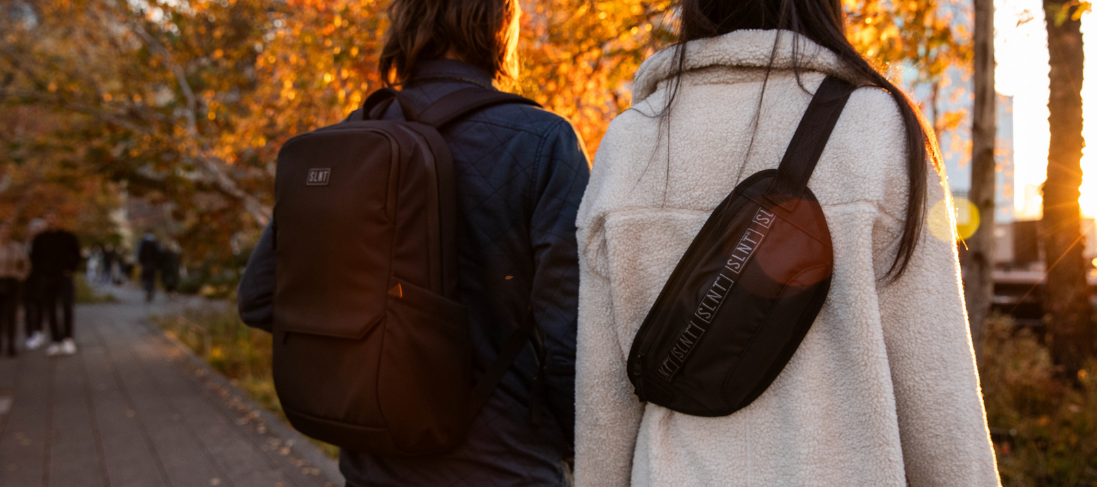 Man and women wearing Essential Faraday Bags 
