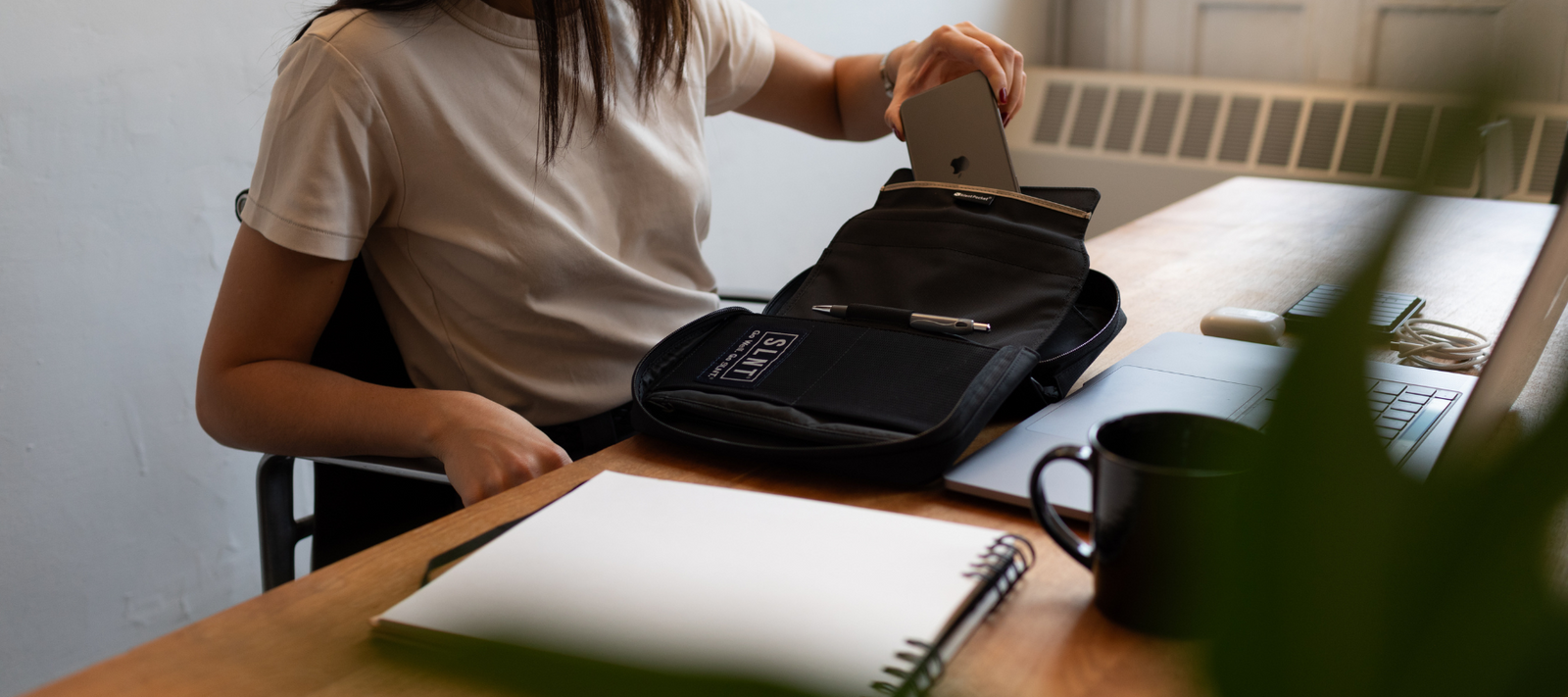 Women putting her phone into a Faraday Sleeve