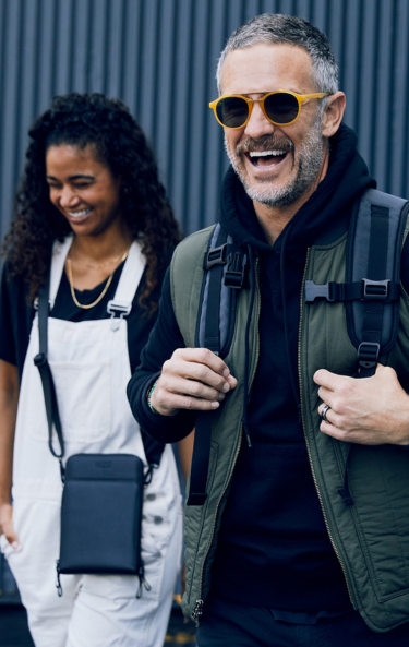 Man and women wearing SLNT Faraday Bags 