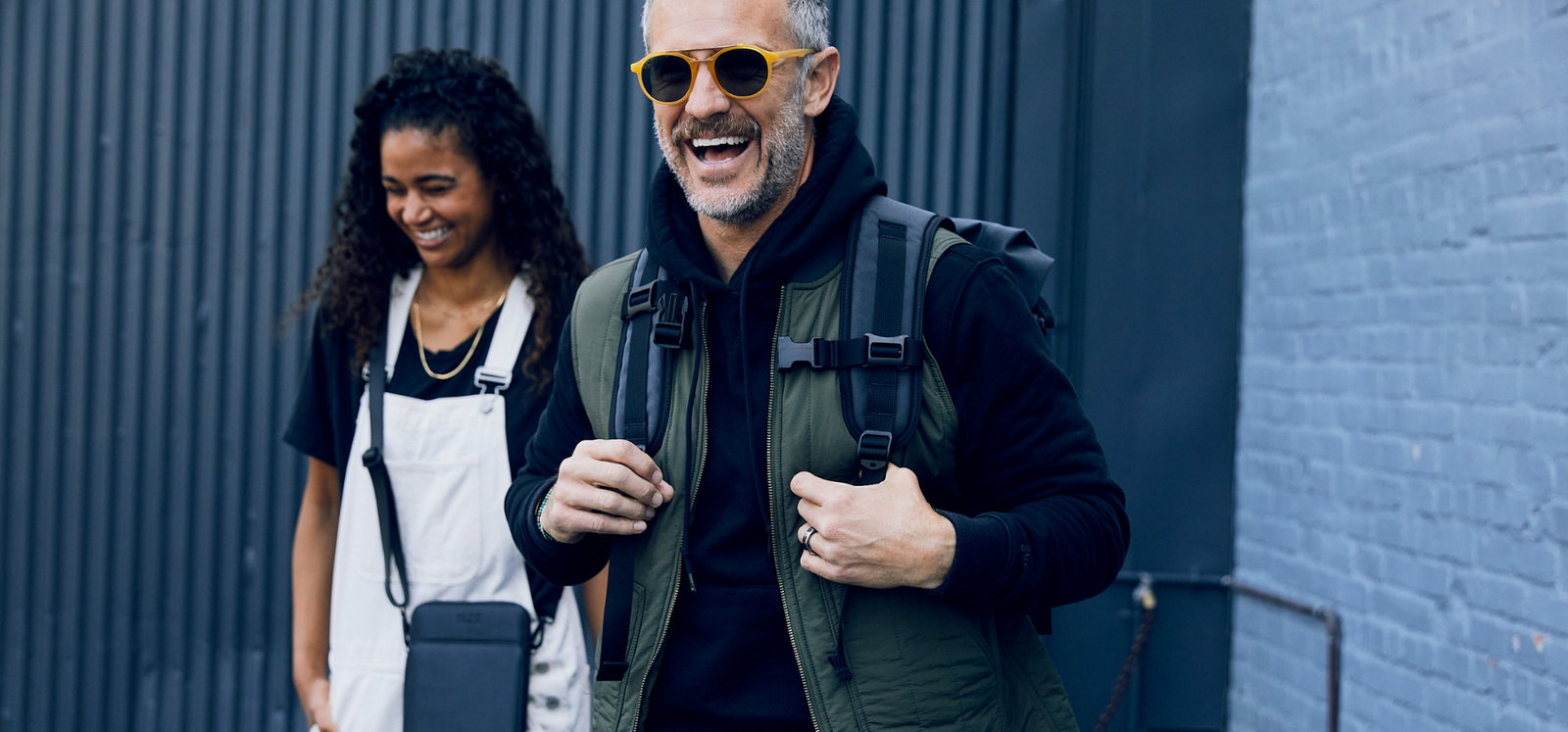 Man and women wearing SLNT Faraday Bags 