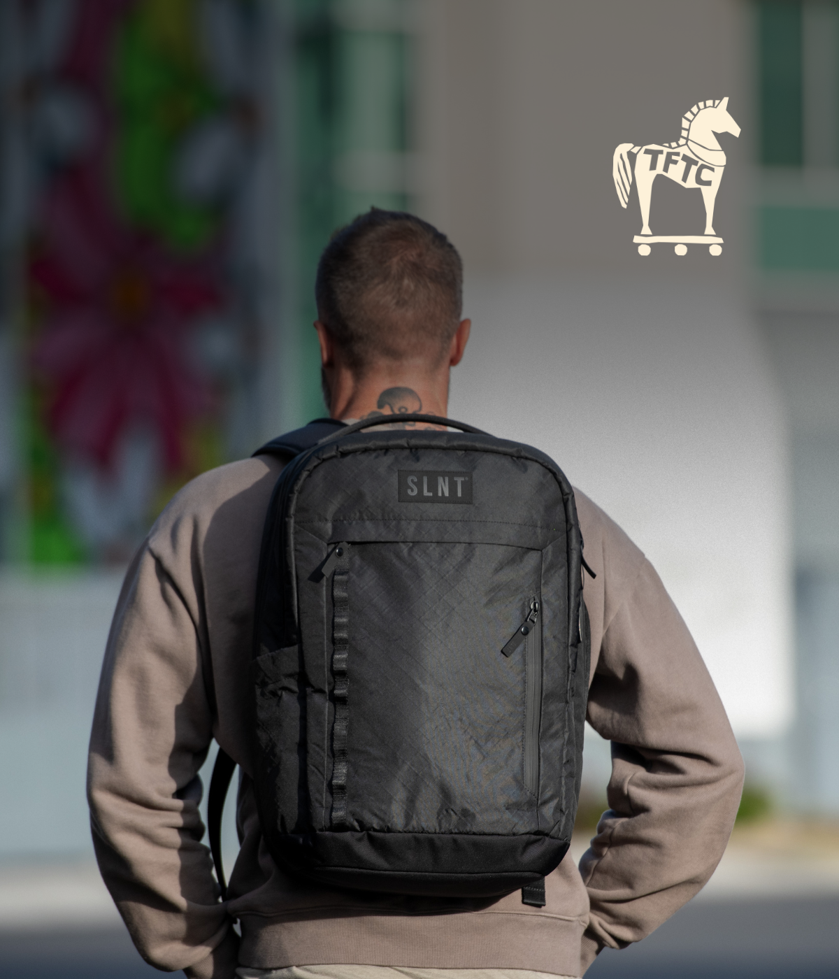 Man Wearing a SLNT Faraday backpack