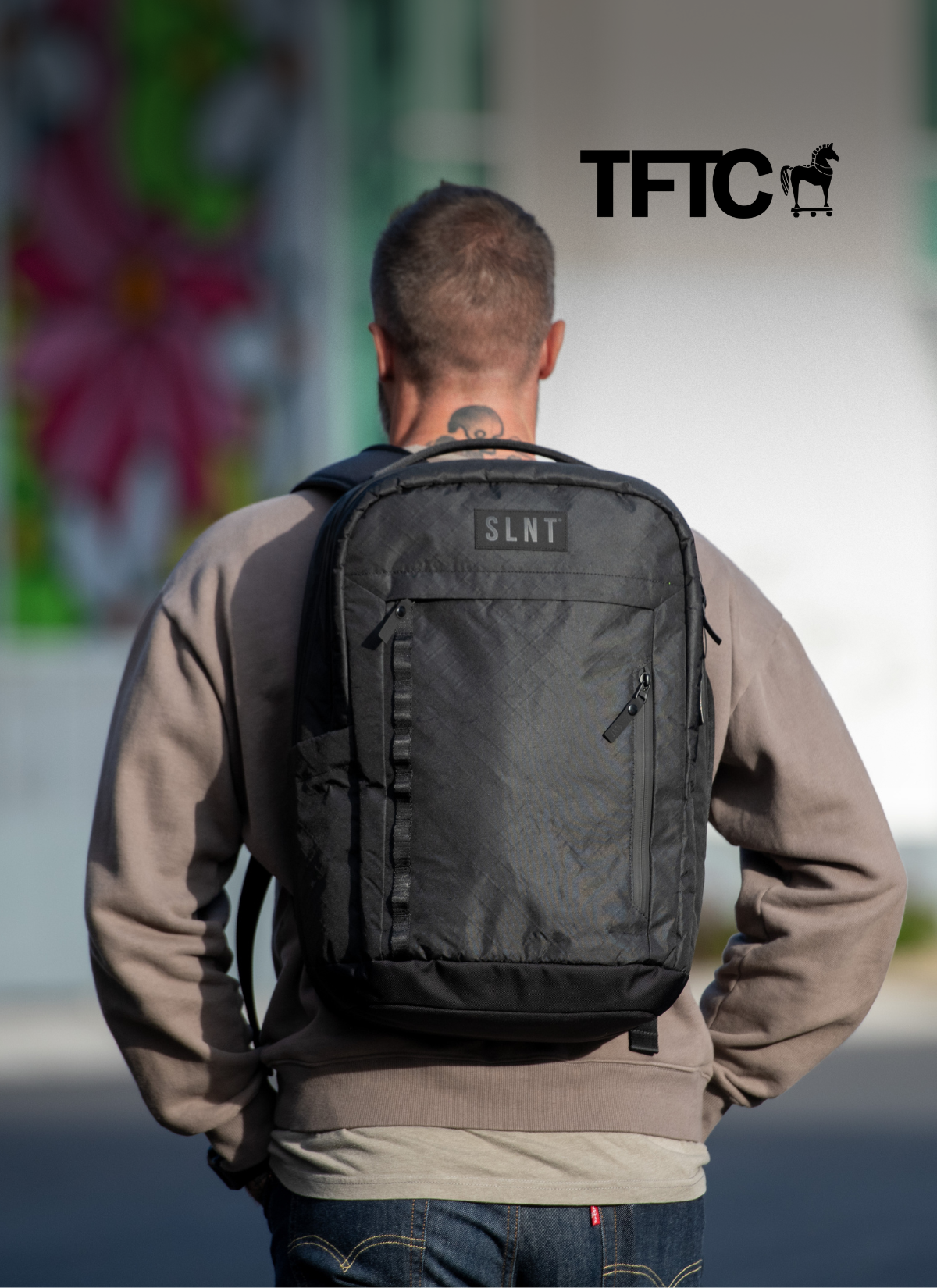 Man Wearing a SLNT Faraday backpack